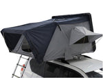 Load image into Gallery viewer, DesertX Basecamp hardshell rooftop tent in grey and black with an attached ladder, mounted on a white SUV.