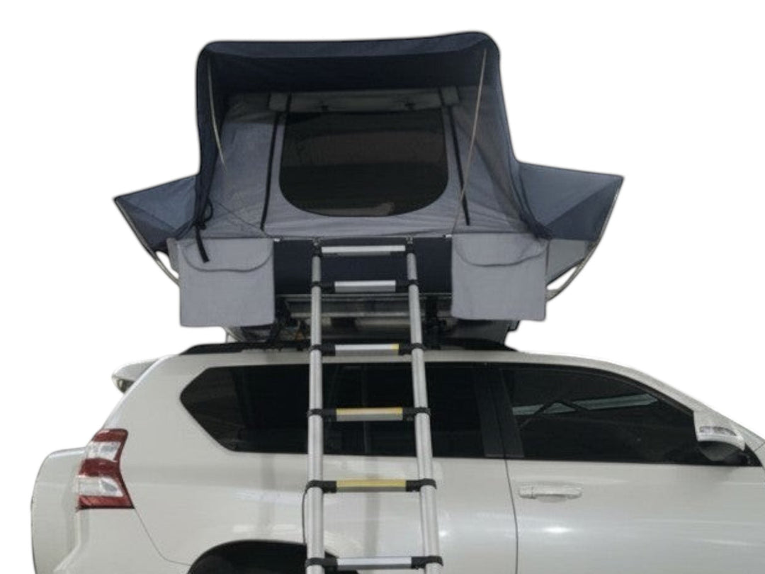 DesertX Basecamp hardshell rooftop tent on a white SUV, featuring a dark blue and grey fabric with a ladder.