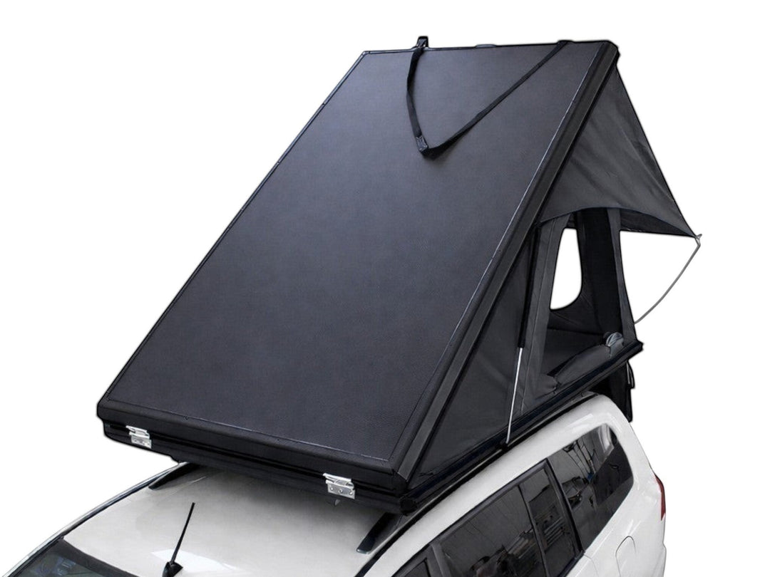 DesertX Trailblazer black two-person hard shell rooftop tent mounted on a white SUV