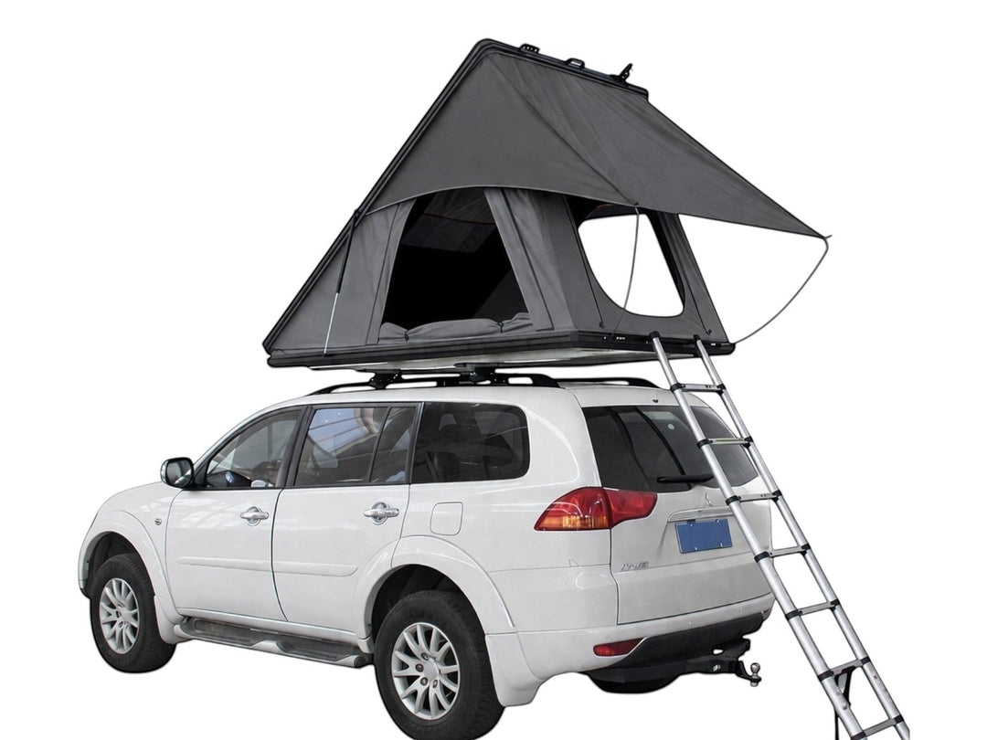 DesertX Trailblazer grey two-person hard shell rooftop tent set up on a white SUV with ladder extended.