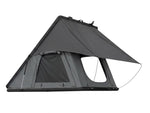Load image into Gallery viewer, DesertX Trailblazer hard shell rooftop tent on a white SUV, grey fabric, with ladder attached.