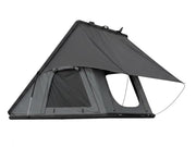 DesertX Trailblazer hard shell rooftop tent on a white SUV, grey fabric, with ladder attached.